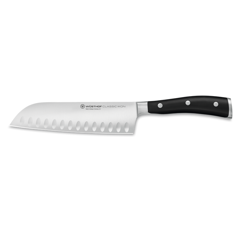 Classic Ikon 7-Piece Knife Block Set featuring a forged German steel santoku knife with hollow edge indentations and a triple-riveted black ergonomic handle.