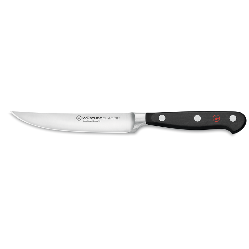 Classic 15-Piece Knife Block Set, Acacia featuring a forged steak knife with a sharp stainless steel blade and triple-riveted black ergonomic handle by WÜSTHOF.