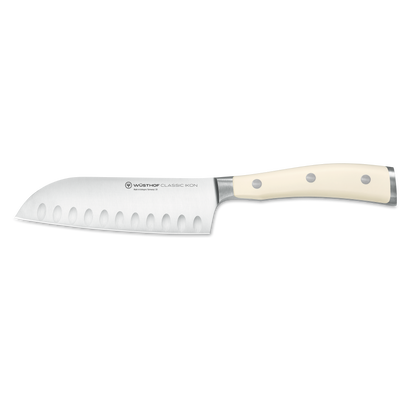 Classic Ikon 5" Hollow Edge Santoku with a forged German steel blade featuring hollowed indentations and a smooth triple-riveted ivory handle for precision cutting.