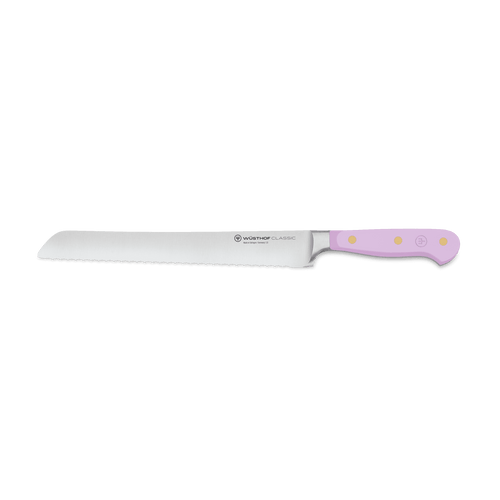 Classic 9" Precision Double-Serrated Bread Knife with a finely serrated German steel blade and a pastel pink ergonomic handle with brass rivets for comfortable grip.