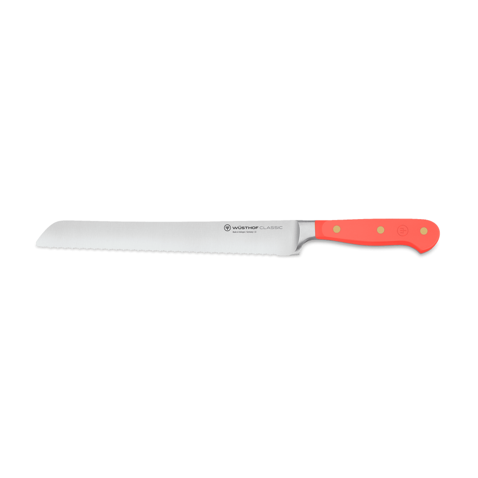 Classic 9" Precision Double-Serrated Bread Knife with bright red ergonomic handle and sharp forged German steel blade for smooth slicing.