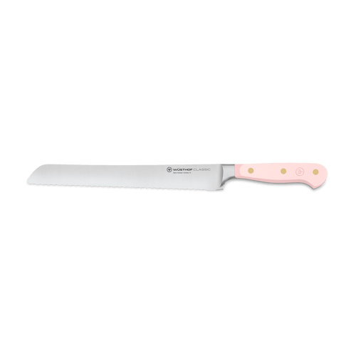 Classic 9" Precision Double-Serrated Bread Knife with a finely crafted serrated blade and a pale pink handle featuring triple rivets for durable, comfortable use.
