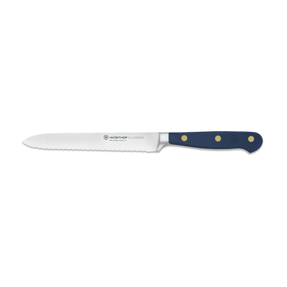 Classic 5" Serrated Utility Knife featuring a polished stainless steel blade and a dark blue triple-riveted handle for precision and durability in the kitchen.