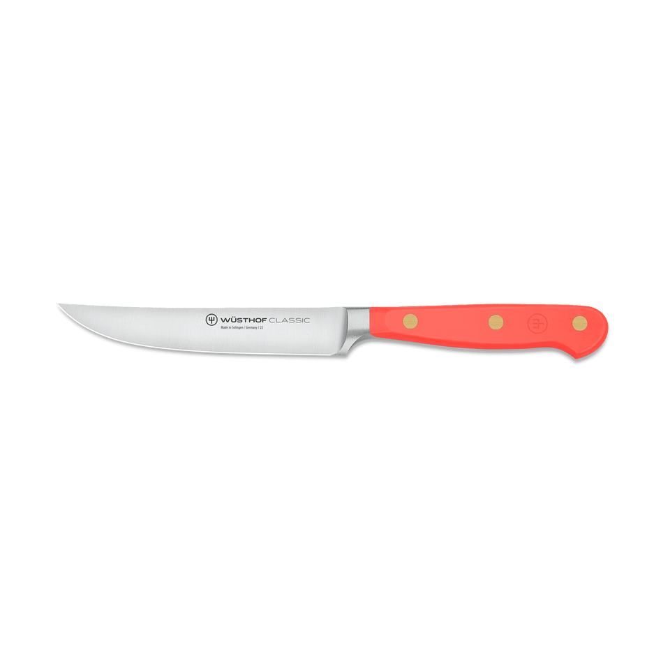 Classic 4 1/2" Steak Knife with a sharp stainless steel blade and a vibrant red handle secured by three brass rivets, designed for precision cutting.