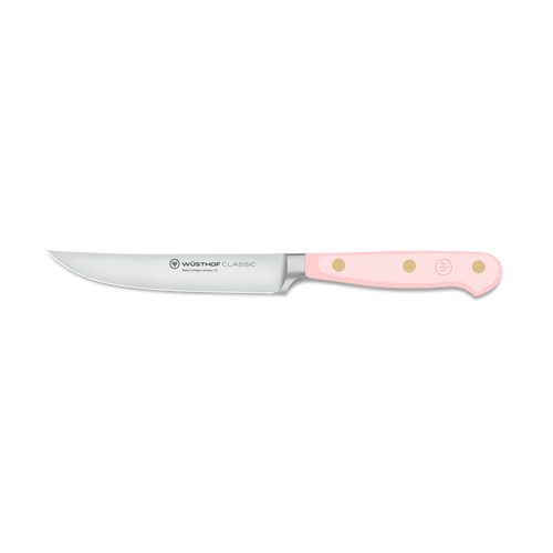 Classic 4 1/2" Steak Knife with a sharp stainless steel blade and a smooth pale pink handle secured by three brass rivets for durability and style.