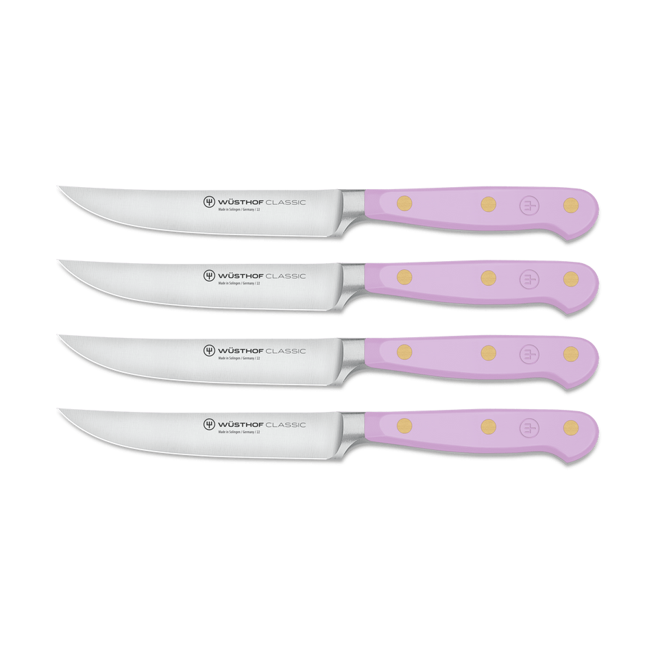 Classic 4-Piece Steak Knife Set featuring light purple ergonomic handles with three brass rivets and sharp forged German steel blades in varying sizes.