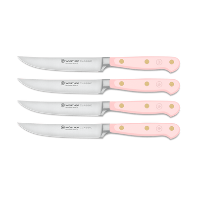 Classic 4-Piece Steak Knife Set featuring forged German steel blades and light pink triple-riveted handles with ergonomic design for precise cutting.