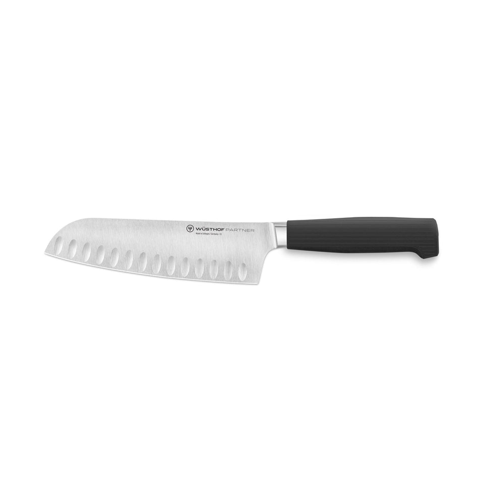 Partner 7” Hollow Edge Santoku featuring a forged German blade with hollow edges and a textured black ergonomic handle for precise and effortless kitchen cutting.