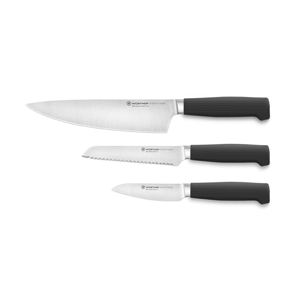 Partner 3-Piece Knife Set featuring forged German blades with textured black ergonomic handles including chef’s, serrated, and paring knives for versatile kitchen use.