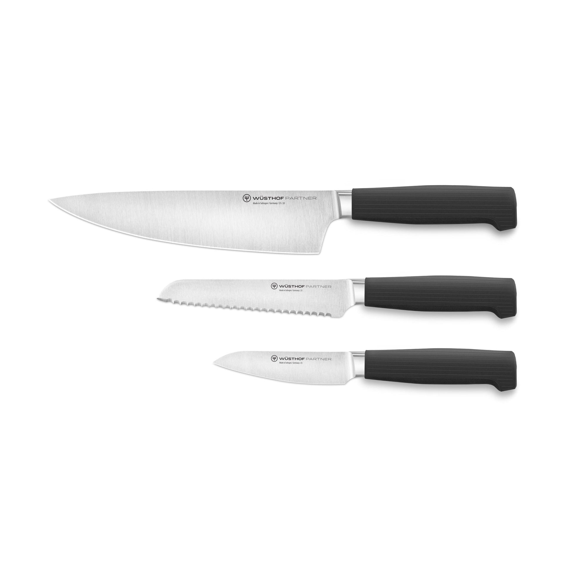 Partner 3-Piece Knife Set featuring forged German blades with textured black ergonomic handles including chef’s, serrated, and paring knives for versatile kitchen use.