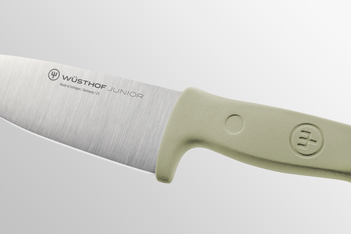 Junior 4" Chef’s Knife for Children with a sharp forged German stainless steel blade and ergonomic light green handle designed for young cooks.