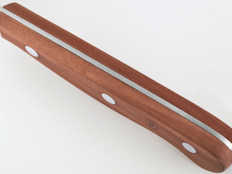 Close-up of the smooth plum wood handle with visible steel tang and rivets on the 4 1/2" Plum Wood Steak Knife.