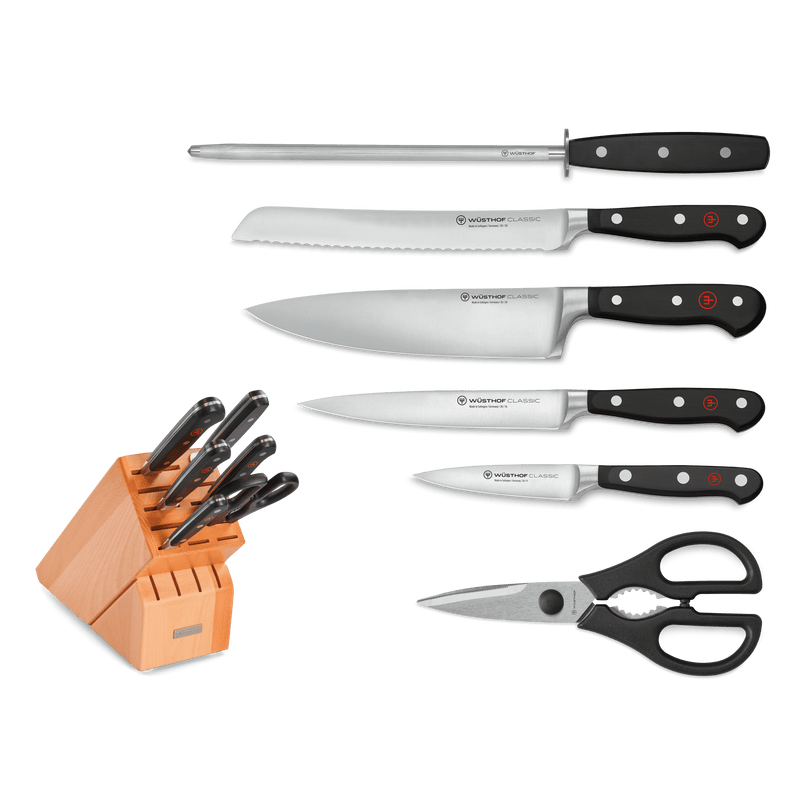 Classic 7-Piece Knife Block Set including forged German kitchen knives with black ergonomic handles, honing steel, kitchen shears, and a wooden storage block.