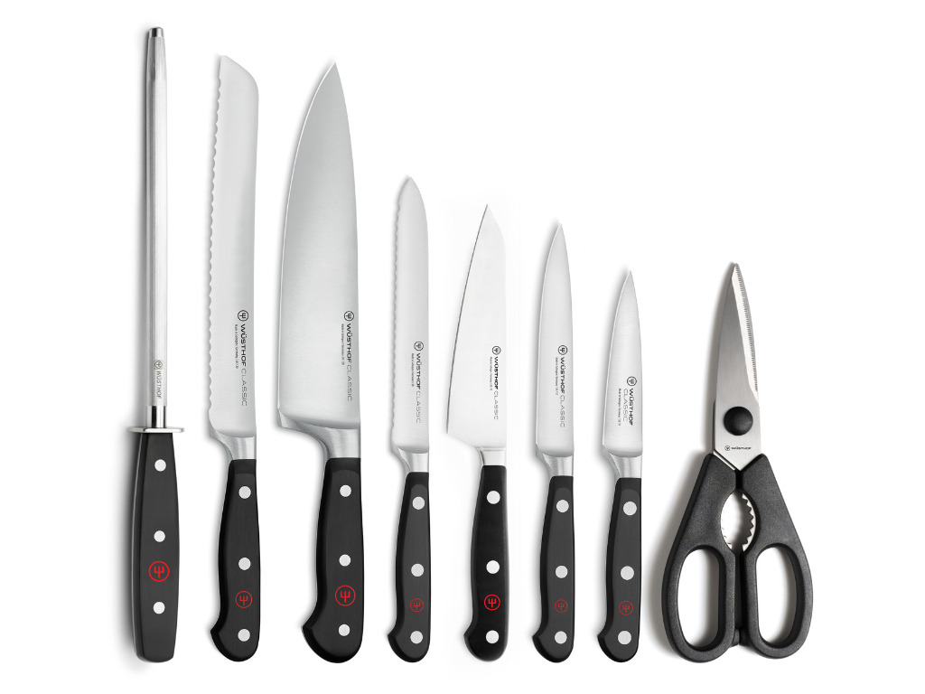 Classic 9-Piece Knife Block Set, Acacia featuring forged German kitchen knives with black ergonomic handles and sharp stainless steel blades alongside multipurpose kitchen shears.