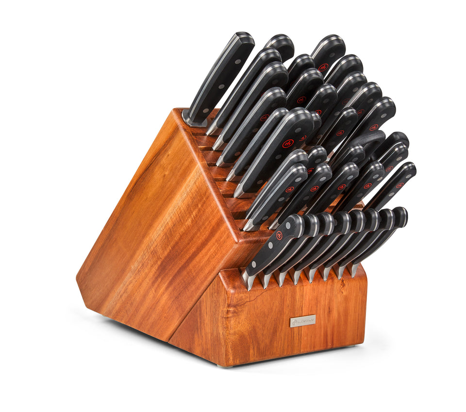 Classic 36-Piece Knife Block Set with forged German blades and black ergonomic handles neatly organized in a polished wooden storage block.