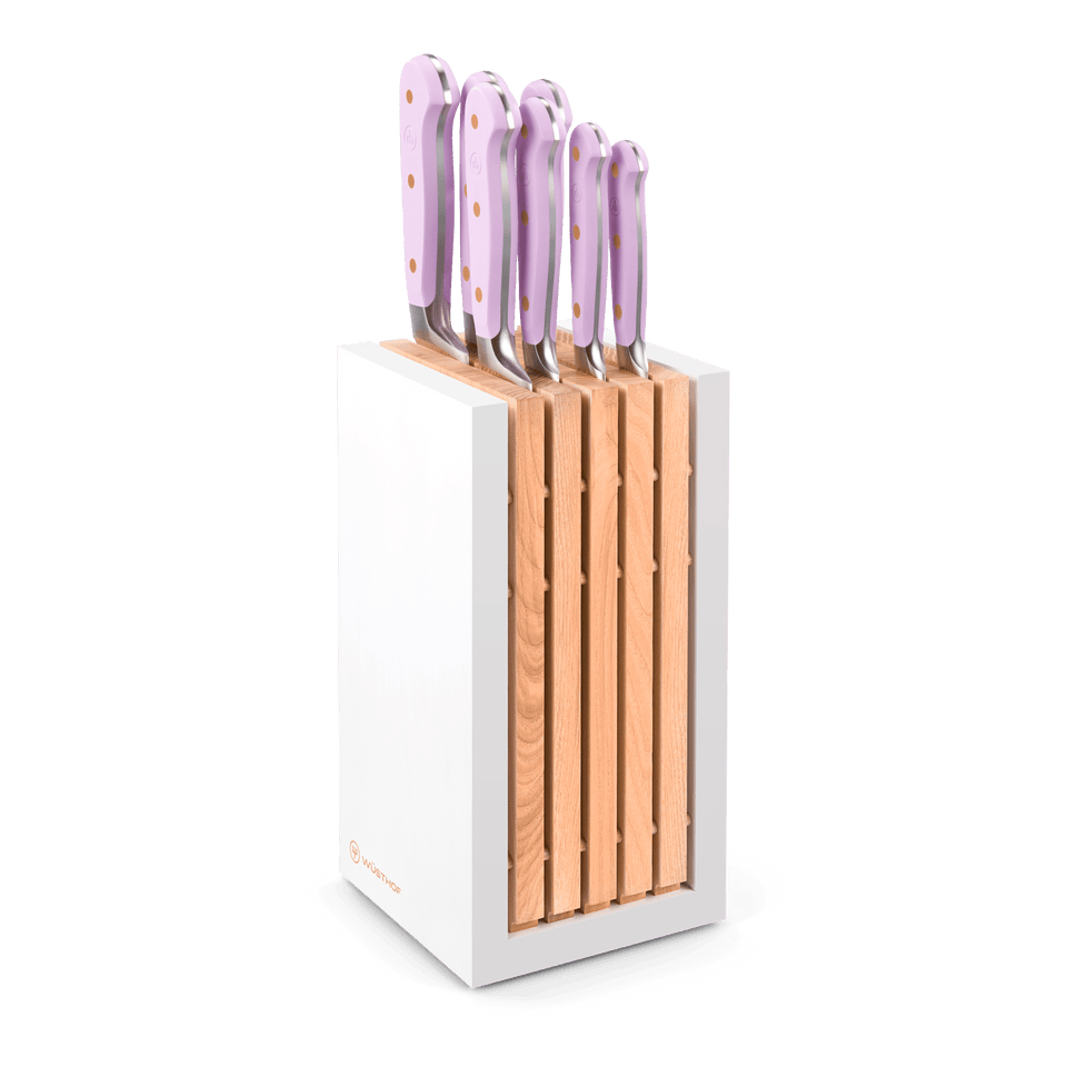 Classic 8-Piece Designer Knife Block Set featuring forged German steel knives with pale pink ergonomic handles and brass rivets in a modern white and wood block.