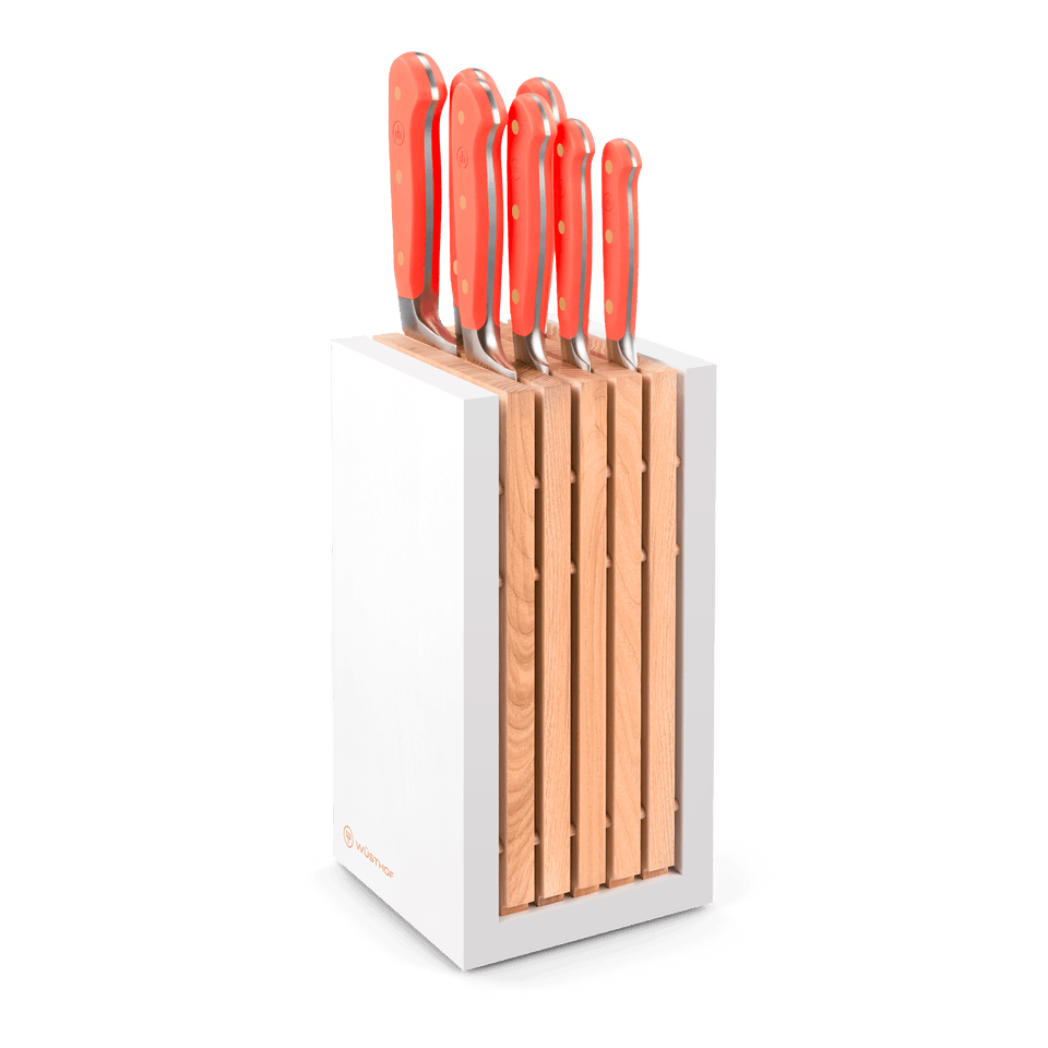 Classic 8-Piece Designer Knife Block Set featuring a white wooden block with neatly arranged forged German steel knives with vibrant red ergonomic handles.