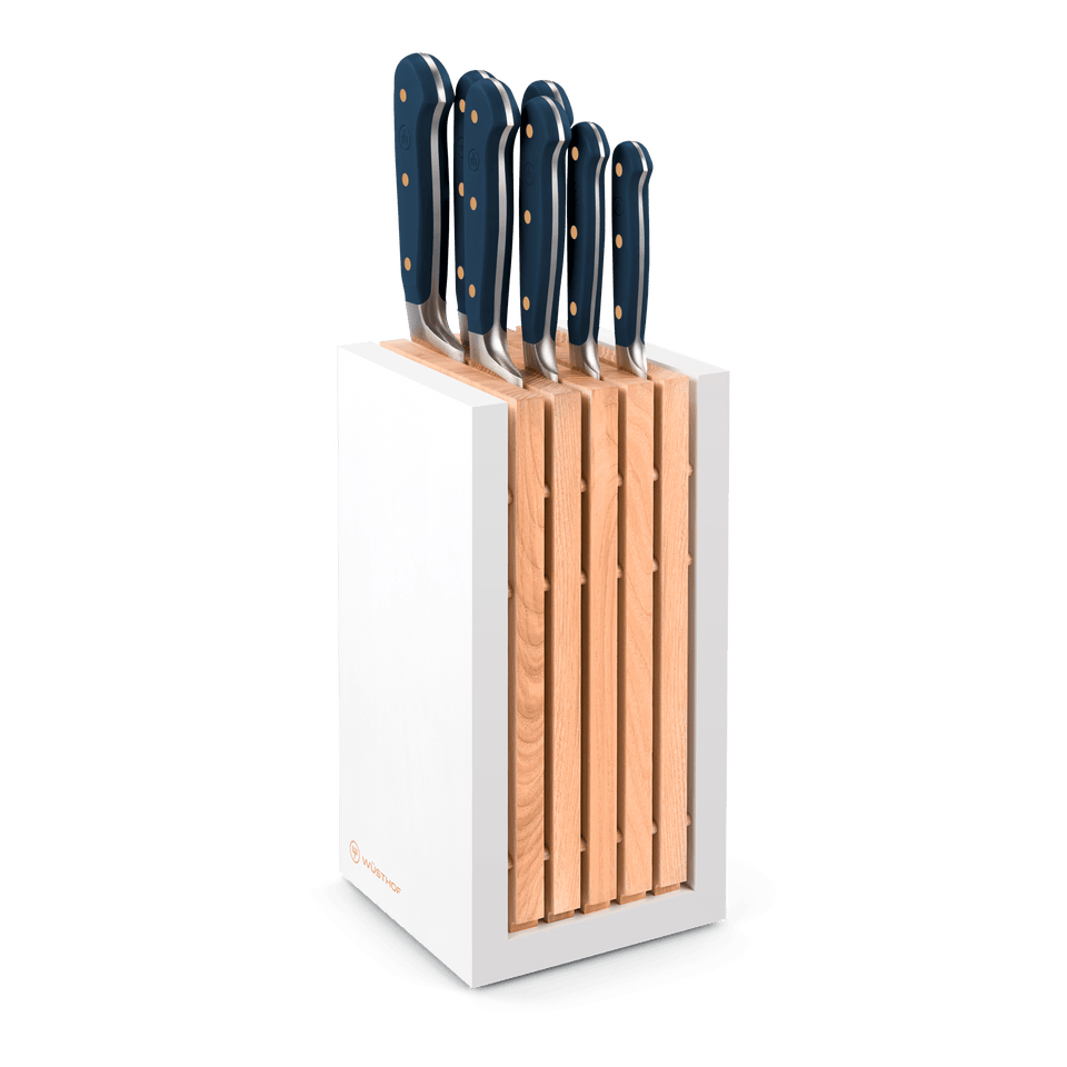 Classic 8-Piece Designer Knife Block Set featuring forged German steel knives with deep blue ergonomic handles and brass rivets in a sleek white and wood block.