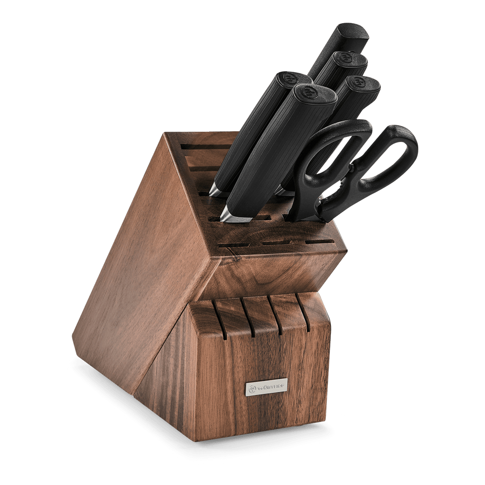 Partner 7-Piece Knife Block Set with forged German blades, black ergonomic handles, kitchen scissors, and a walnut wood block for organized storage.