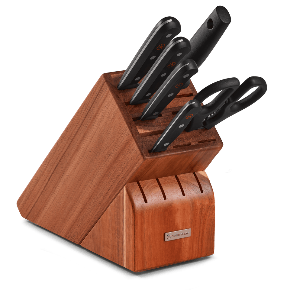 Gourmet 7-Piece Knife Block Set featuring six forged German kitchen knives with black ergonomic handles and a wooden block with integrated knife sharpener and kitchen shears.