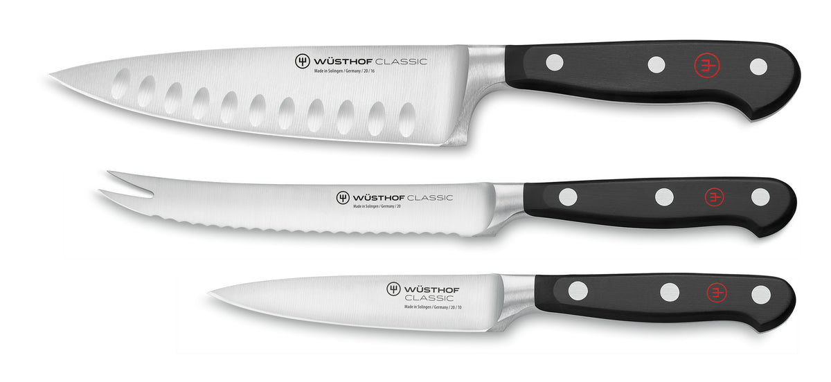 Classic 3-Piece Ultimate Chef's Knife Set featuring forged German knives with black ergonomic handles, including chef, serrated utility, and paring blades.