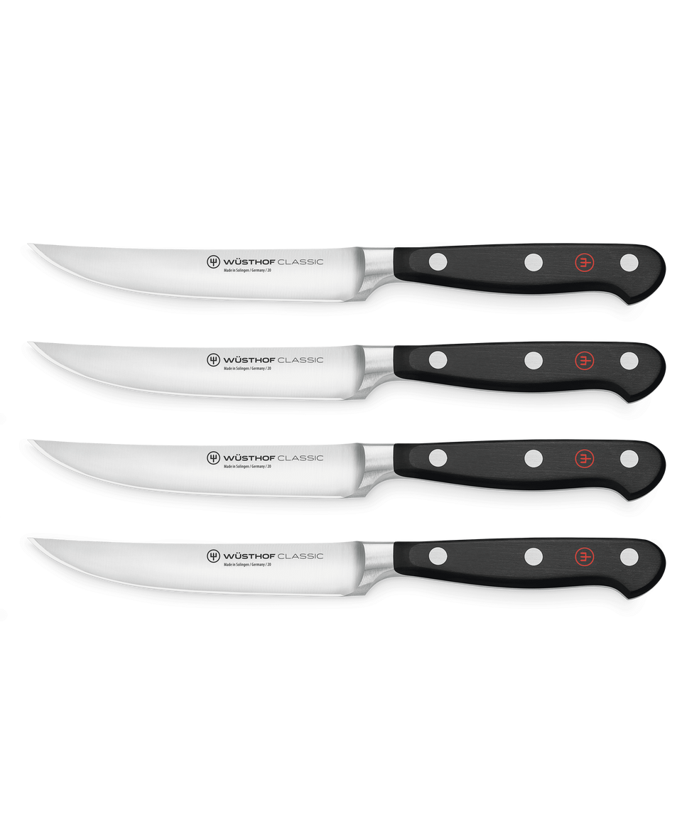 Classic 4-Piece Steak Knife Set featuring forged German steel blades with triple-riveted black handles for precise cutting and balanced grip.