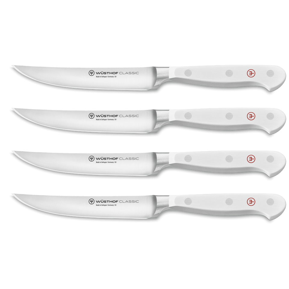 Classic 4-Piece Steak Knife Set with white ergonomic handles featuring triple rivets and sharp German-forged blades for precise slicing.
