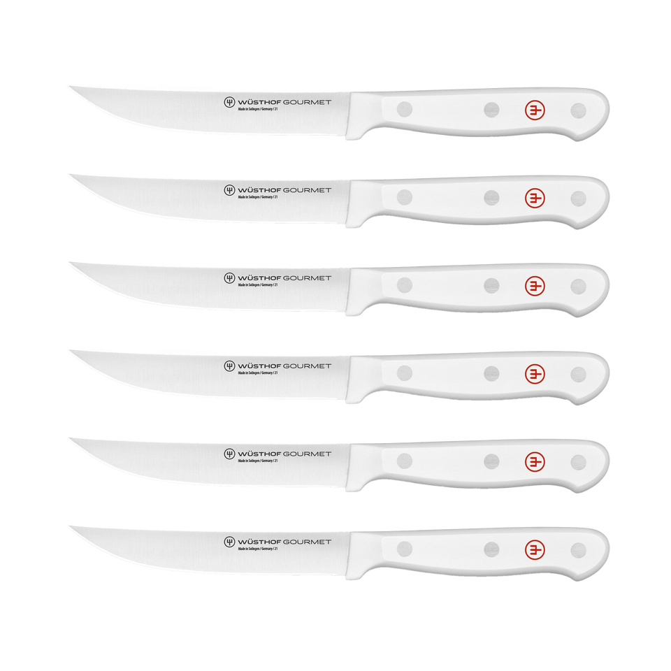 Gourmet 6-Piece Steak Knife Set with white triple-riveted ergonomic handles and serrated forged German steel blades for precise cutting.