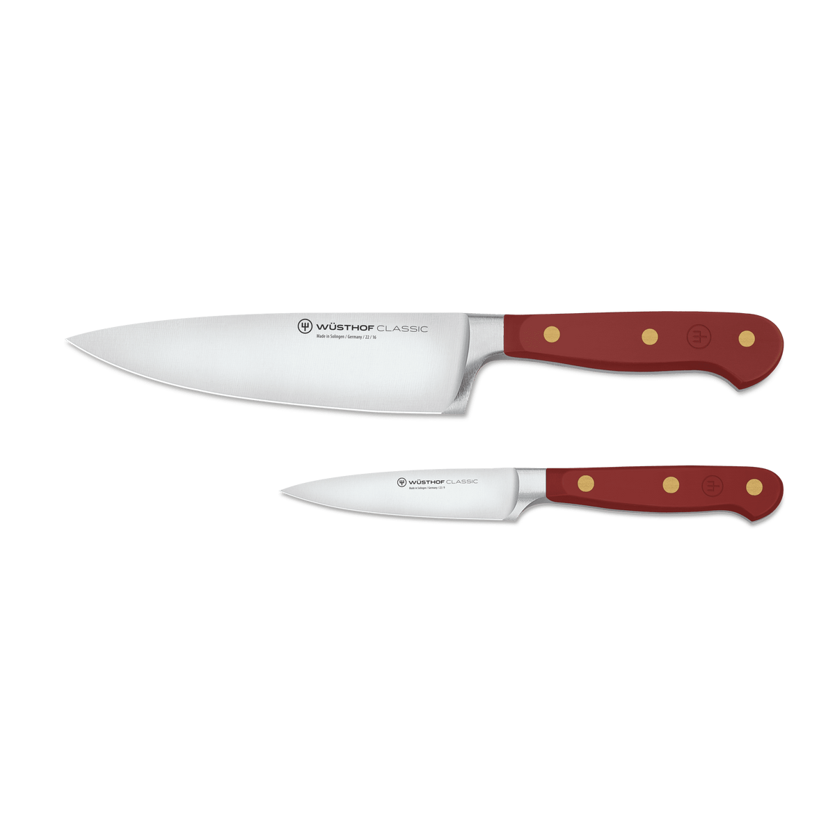 Classic 2-Piece Knife Set - Tasty Sumac displaying a forged German chef’s knife and paring knife with deep red ergonomic handles and brass rivets.
