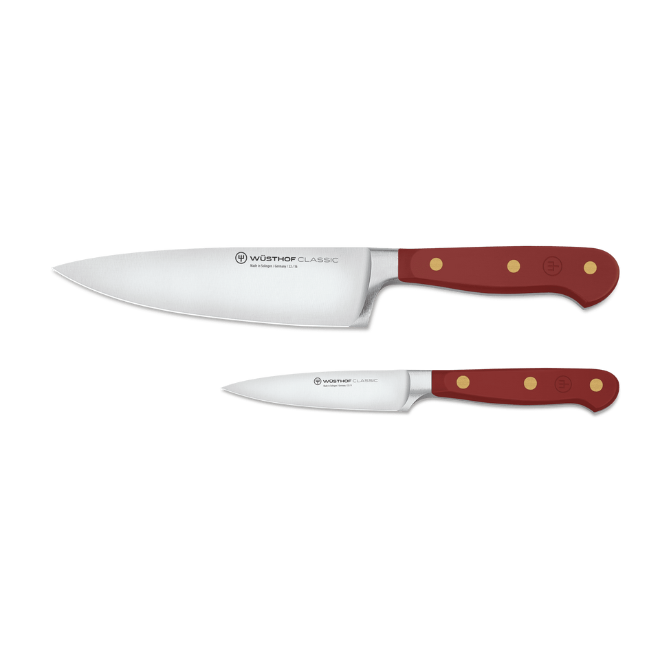 Classic 2-Piece Knife Set - Tasty Sumac displaying a forged German chef’s knife and paring knife with deep red ergonomic handles and brass rivets.