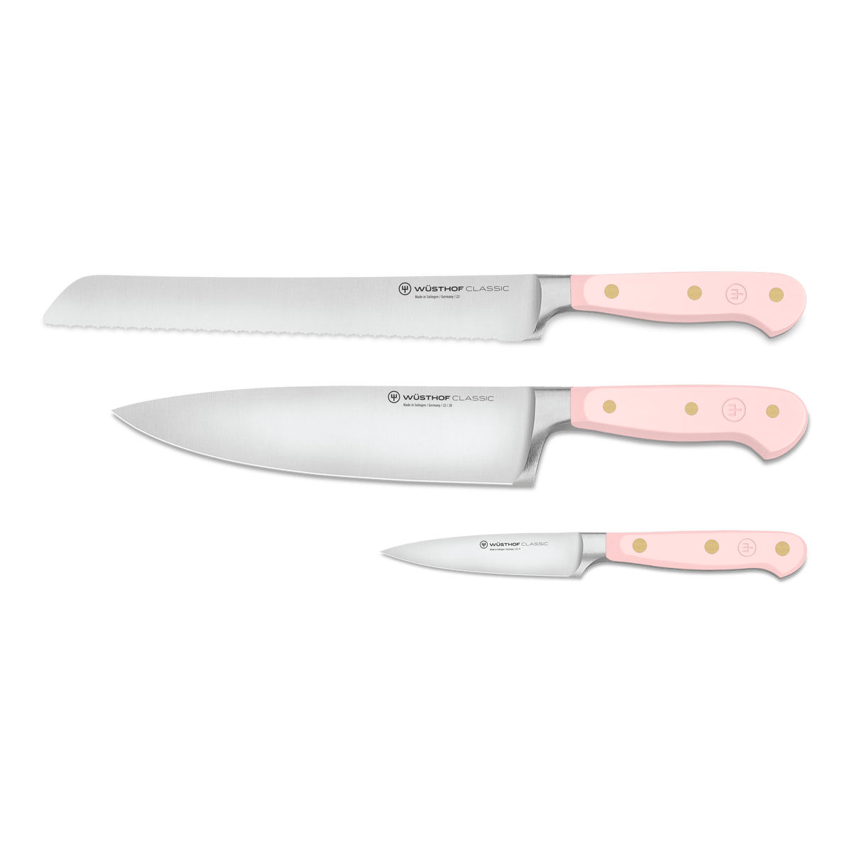 Classic 3-Piece Essential Knife Set - Pink Himalayan Salt displaying forged German blades with serrated and chef knife edges and ergonomic light pink handles with brass rivets.
