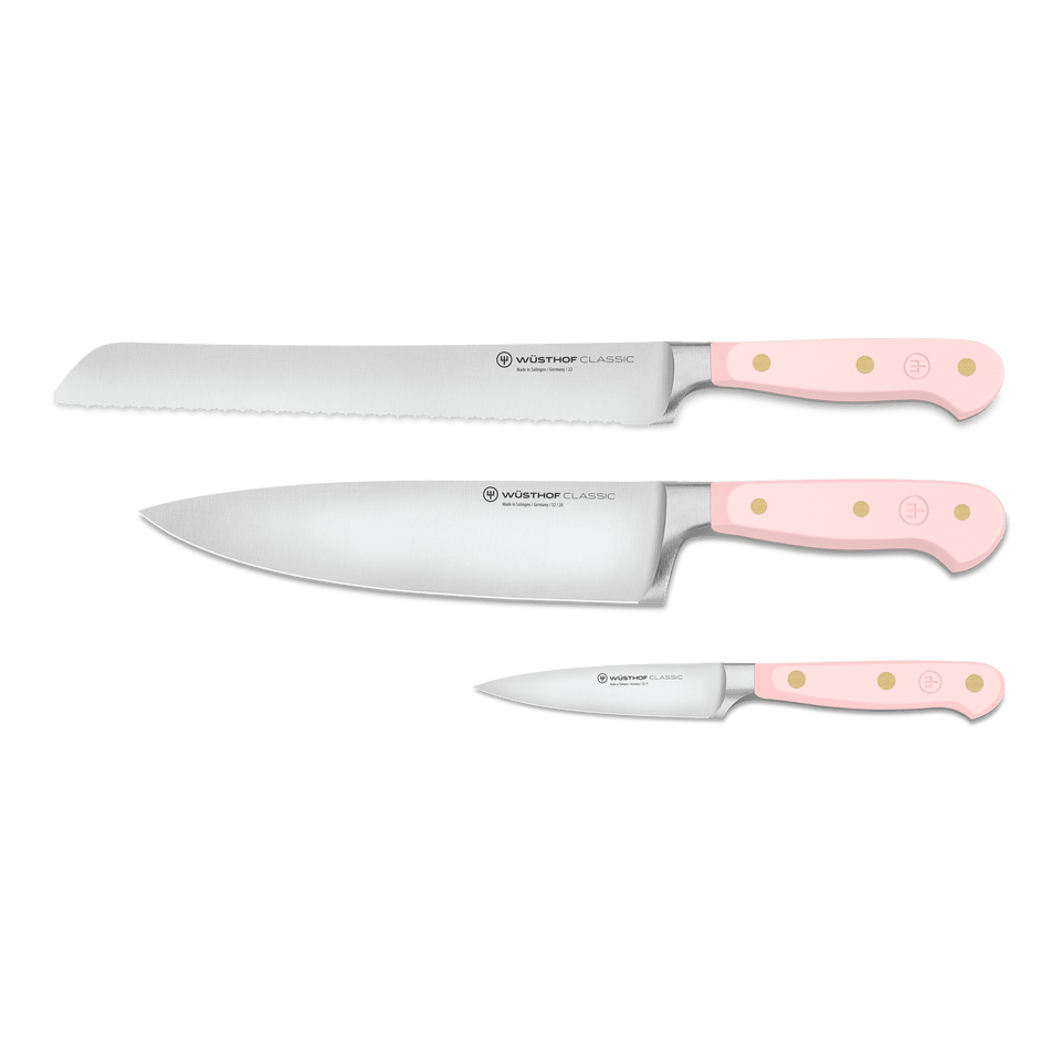Classic 3-Piece Essential Knife Set - Pink Himalayan Salt displaying forged German blades with serrated and chef knife edges and ergonomic light pink handles with brass rivets.