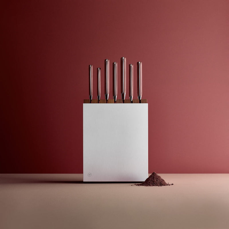 Set of knives in a white block on a red background