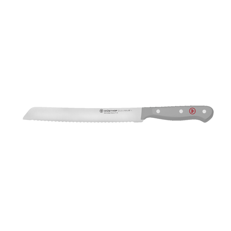 Gourmet 7-Piece In-Drawer Knife Set featuring a serrated bread knife with a forged German blade and gray ergonomic handle with polished rivets and red logo.