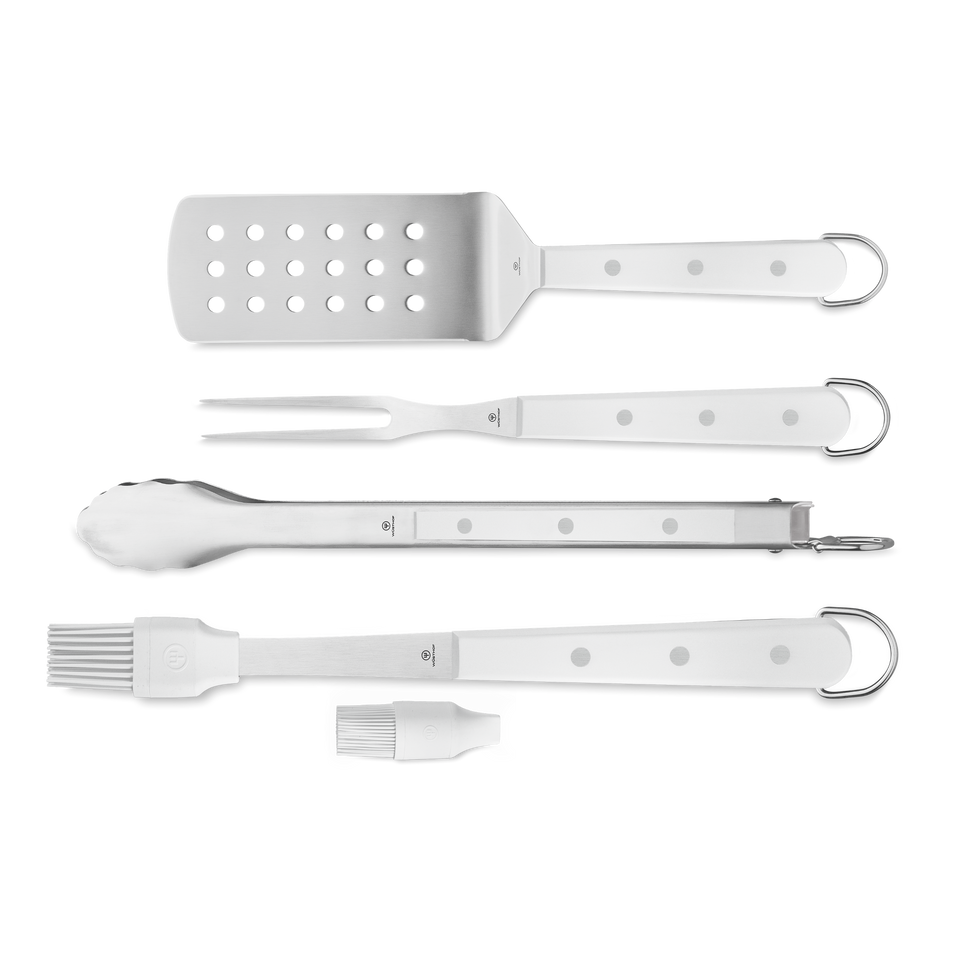 4-Piece BBQ Set with perforated stainless steel spatula, two-pronged fork, locking tongs, and silicone basting brush featuring white riveted handles and hanging loops.