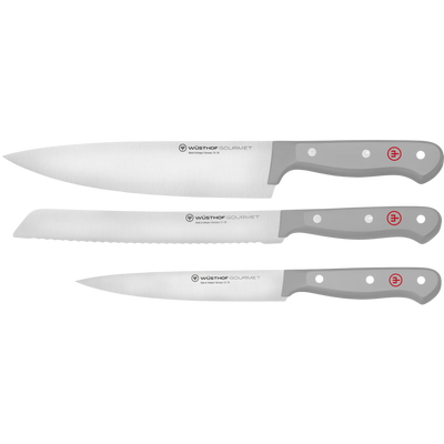 Three forged German kitchen knives with sleek grey handles, including a chef's knife, bread knife, and paring knife from the Gourmet Grey 3-Piece Starter Set.