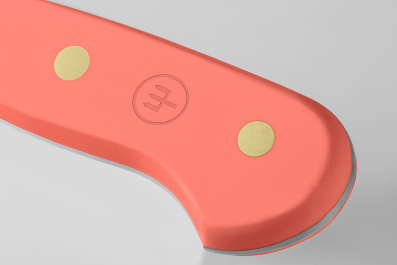 Classic 2-Piece Knife Set - Coral Peach featuring a close-up of a smooth ergonomic coral peach handle with brass rivets and embossed WÜSTHOF logo detail.