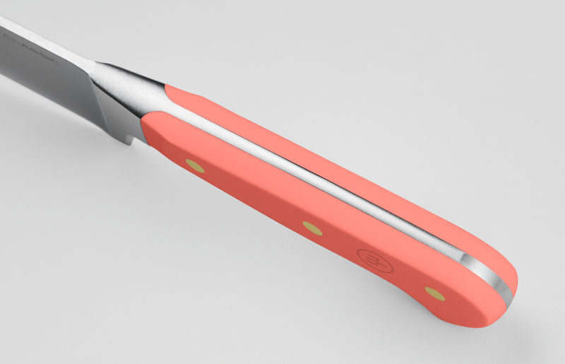 Classic 2-Piece Knife Set - Coral Peach close-up of a forged German kitchen knife handle in coral peach with brass rivets, offering ergonomic comfort.
