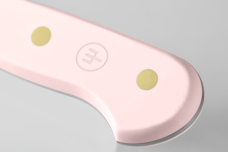 Classic 4-Piece Steak Knife Set featuring a close-up of the ergonomic light pink handle with two brass rivets and subtle embossed logo.