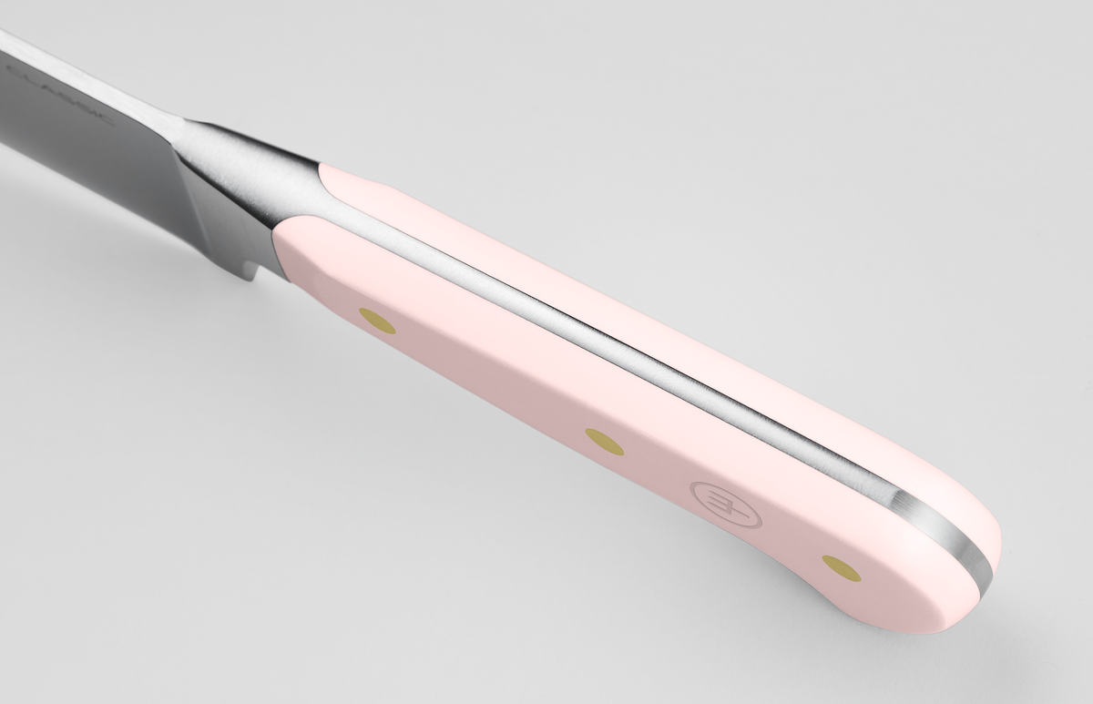 Classic 4-Piece Steak Knife Set featuring a close-up of the ergonomic light pink handle with three brass rivets and full tang forged German steel construction.