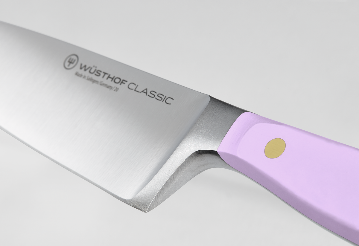 Classic 6" Chef's Knife with a forged German steel blade featuring a full bolster and a lavender synthetic handle secured by a single brass rivet.