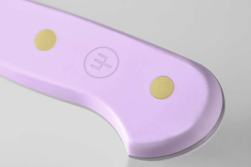 Close-up of the Classic 4 1/2" Steak Knife handle in soft lavender with two brass rivets and an embossed logo for sturdy grip and refined craftsmanship.