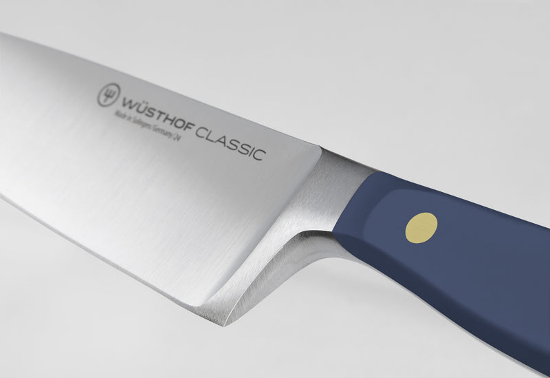 Classic 6" Chef's Knife featuring a forged German steel blade with a full bolster and a navy blue handle secured by a single brass rivet for precision and durability.