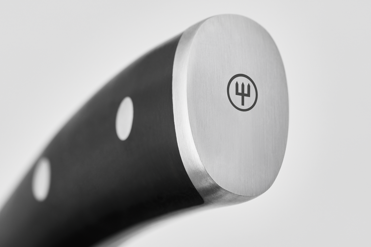 Close-up of a knife handle with a brand logo on a light gray background
