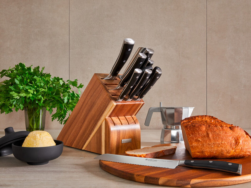 Classic Ikon 11-Piece Knife Block Set with forged German knives featuring polished stainless steel blades and triple-riveted black handles in a wooden block.