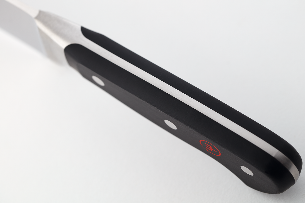 Close-up of the Classic 4-Piece Steak Knife Set handle showing the full tang construction with triple rivets and ergonomic black grip featuring a red logo.