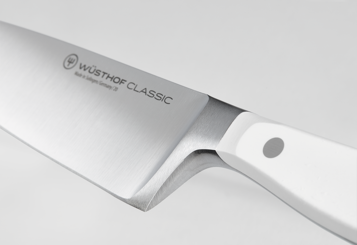 Classic 8" Chef's Knife with a polished forged German steel blade and a white synthetic handle featuring a smooth bolstered transition for durability and balance.
