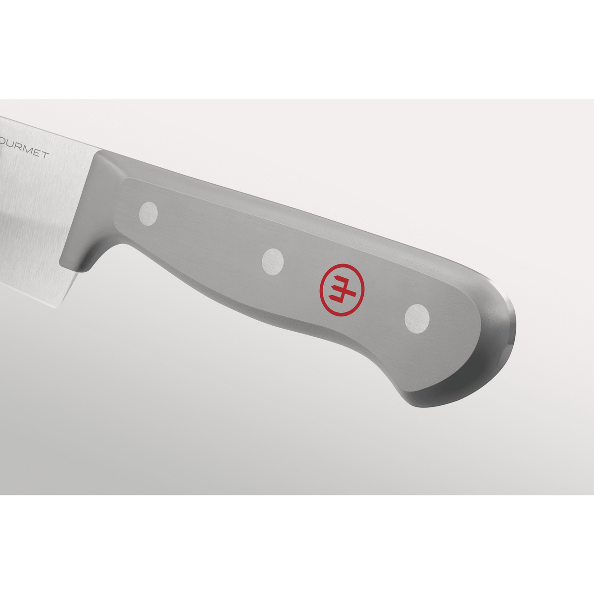 Close-up of a grey ergonomic handle with three metal rivets and a subtle red emblem on a forged German chef's knife from the Gourmet Grey 3-Piece Chef's Set.