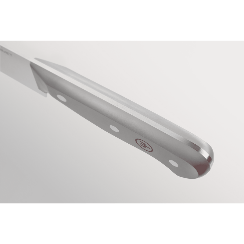 Close-up of a sleek stainless steel handle with triple rivets and a subtle branded emblem on a knife from the Gourmet Grey 3-Piece Chef's Set.