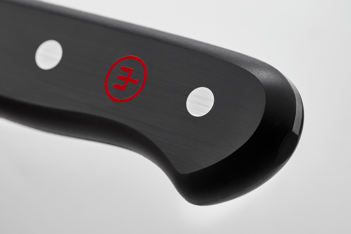 Gourmet 2 3/4" Trimming Knife featuring a close-up of a dark ergonomic handle with two steel rivets and a red embossed logo for secure grip and durability.